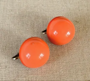 Fun vintage coral orange colored acrylic ball clip earrings from the late 1960s